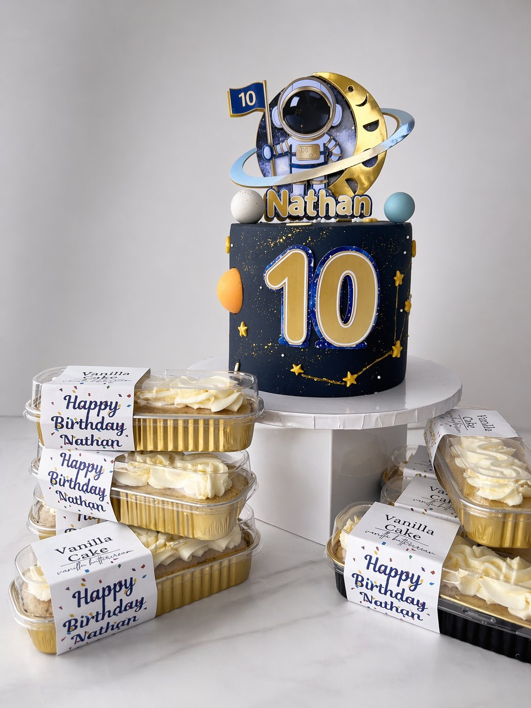 Custom space-themed birthday cake with personalized mini loaves